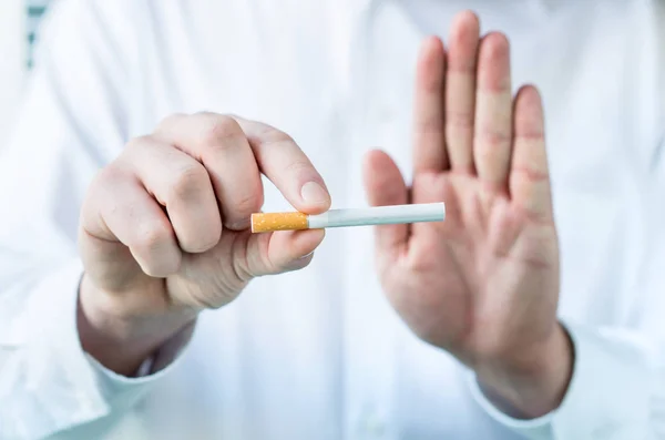Доктор Каже Кинути Палити Тримаючи Сигарету Між Пальцями Показуючи Знак — стокове фото