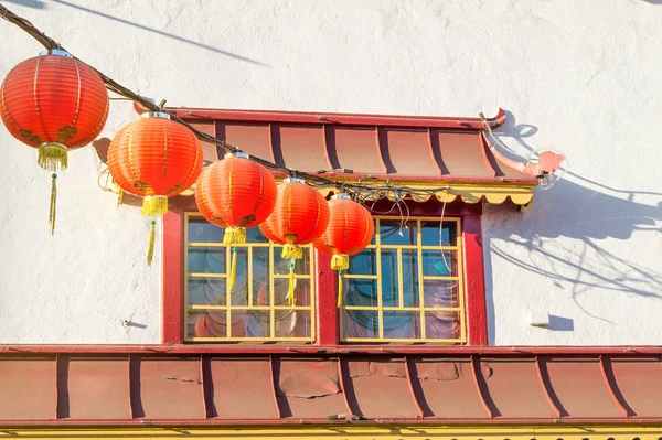 Traditional Chinese window and lanterns in Chinatown in an old building.