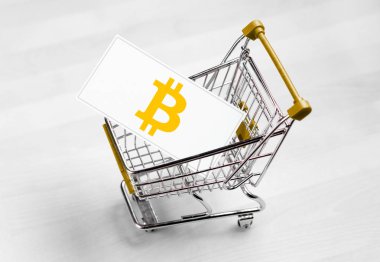 Bitcoin logo alışveriş sepeti bir iş kartı. Satın alma veya satma cryptocurrency kavramı.