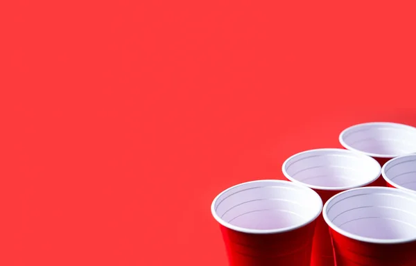 Red party cup and beer pong tournament background template. Alcohol containers with negative copy space.