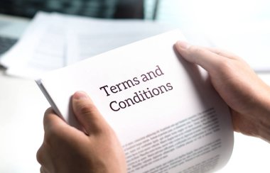 Terms and conditions text in legal agreement or document about service, insurance or loan policy. Lawyer or client holding contract paper in office. clipart