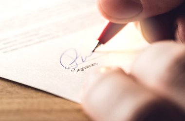 Man writing signature with pen on paper. Settlement for acquisition, business deal, bank loan or rental apartment. Signing contract, agreement, car lease or legal document. The signature is made up. clipart