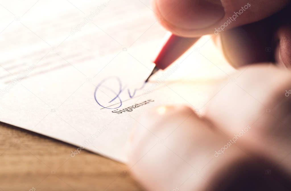 Man writing signature with pen on paper. Settlement for acquisition, business deal, bank loan or rental apartment. Signing contract, agreement, car lease or legal document. The signature is made up.