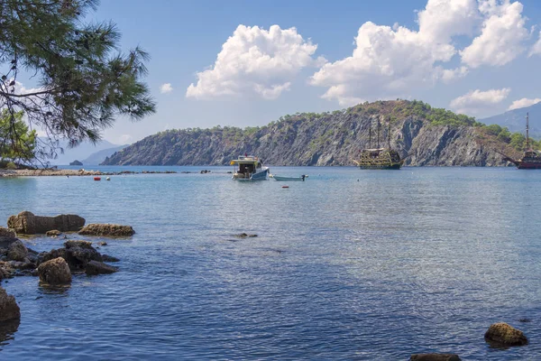 quiet bay in the area of the historic ruins of the city of Phaselis, beautiful sea, green vegetation, ships and yachts in anchorage