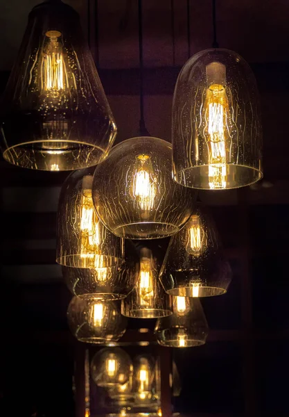 a group of modern pendant lamps, with electric lamps on