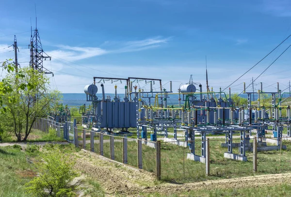 electrical distribution transformer substation, against the background of green vegetation