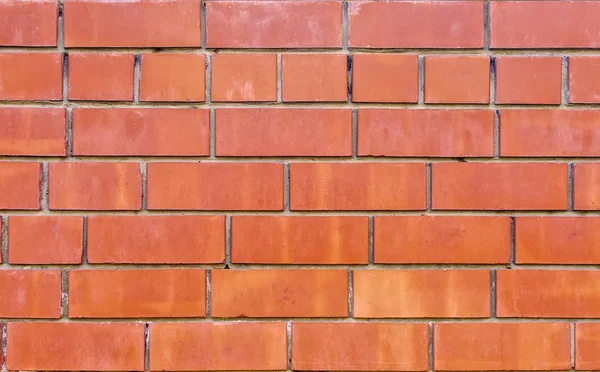 modern masonry wall of red ceramic bricks bonded