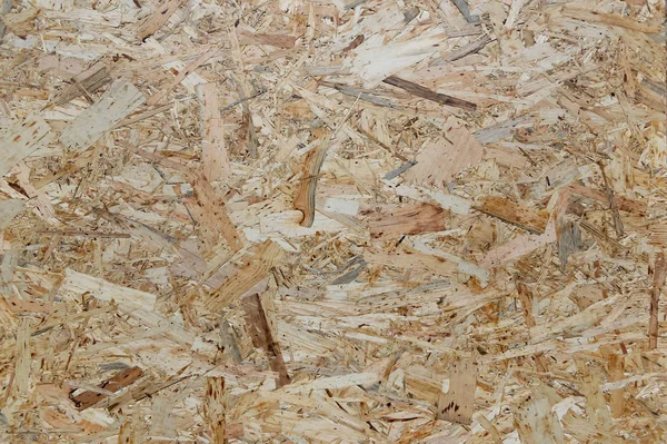 OSB boards are made of wood chips. Top view OSB veneer background.