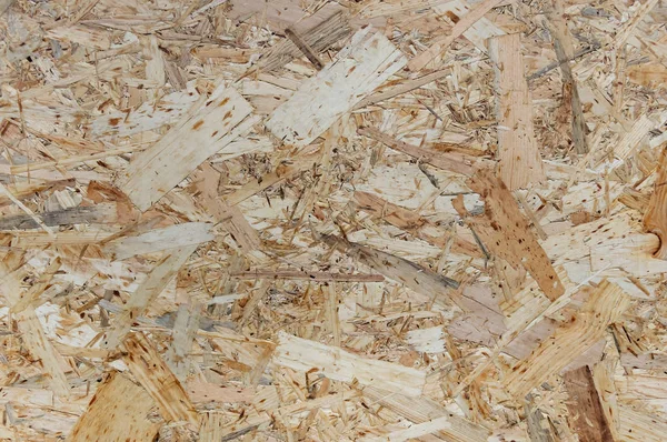 OSB boards are made of wood chips. Top view OSB veneer background.