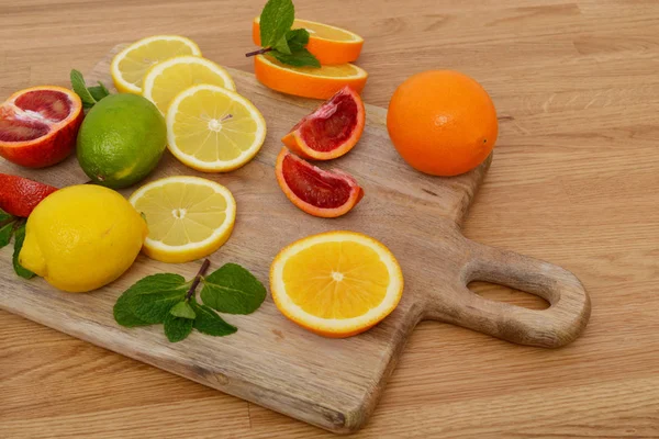 Mix van verse citrusvruchten op de houten tafel — Stockfoto