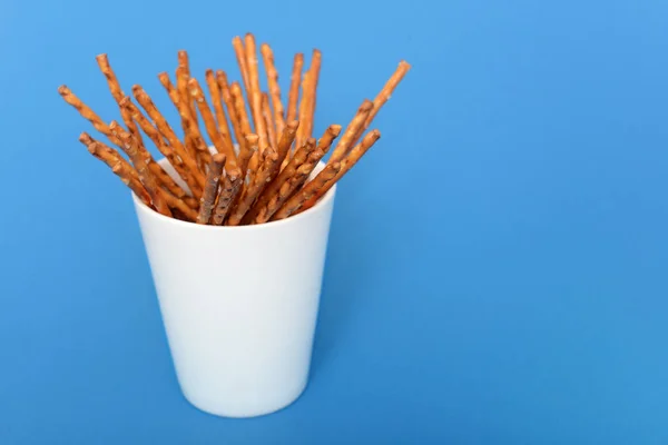 Heap of salted sticks in a white cup — Stock Photo, Image