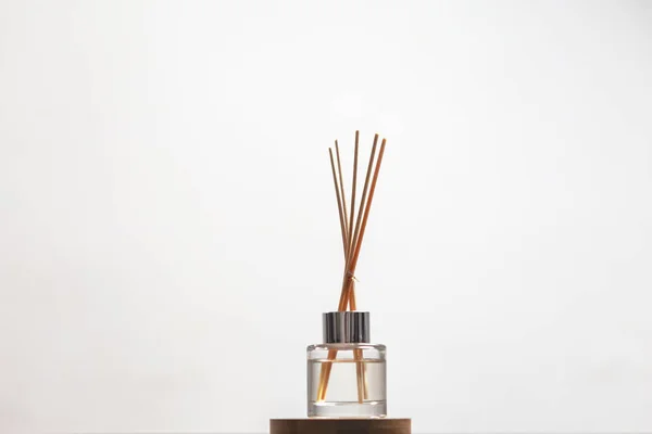 bottle of fragrance diffuser with sticks isolated . air freshener . art of living concept