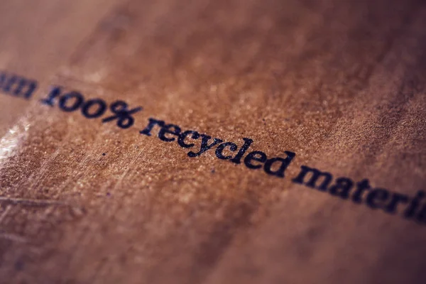 Close up of Recycled material text on cardboard . environment issues . saving the planet concept — Stock Photo, Image