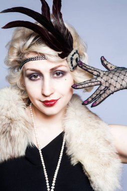 Retro tüyler ve dantel eldiven ile şapkalı bir kız portresi