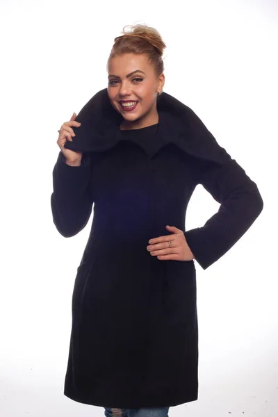 Blonde in a black coat with a large collar
