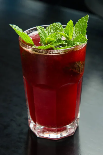 Berry juice in a glass with mint leaves
