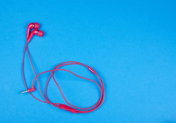 Bright red earbud headphones — Stock Photo, Image