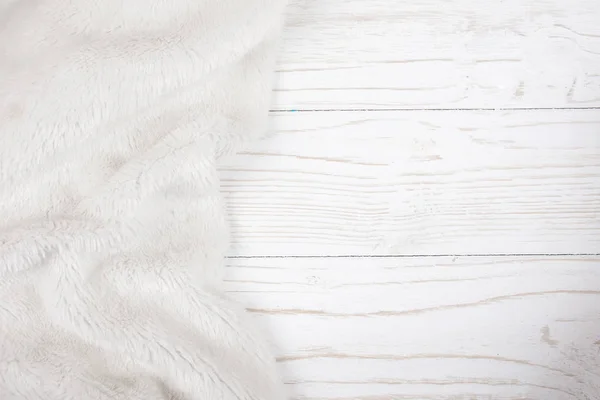 White fur on a worn white wooden background