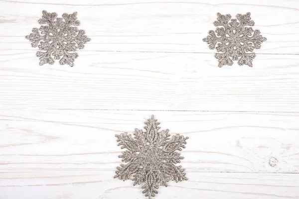 Snowflakes on a white wooden background — Stock Photo, Image