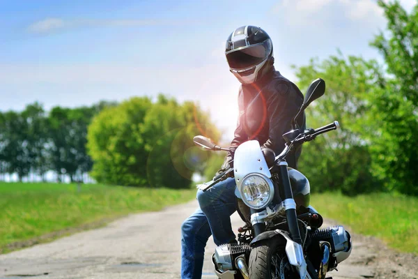 ヘルメットと革のジャケットのモーターサイク リストが彼のオートバイを屋外に座っています バイク旅行の背景 — ストック写真