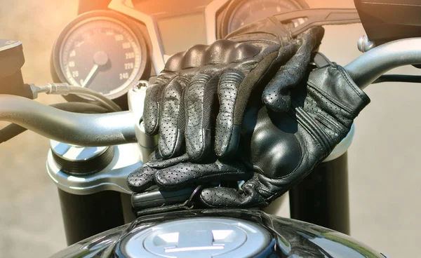 Motorbike background wallpaper. Motorcycle gloves on a fuel tank.
