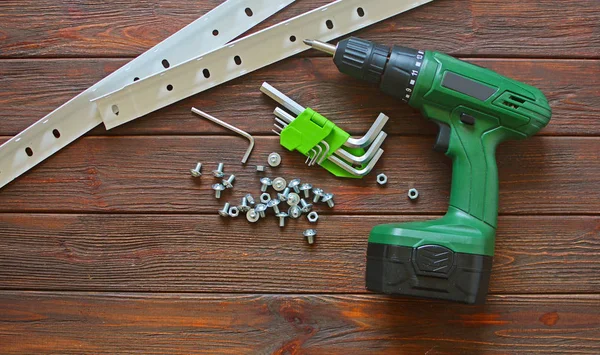 Screwdriver close-up. Tools for assembling furniture on a wooden background.