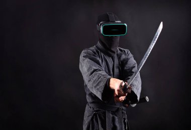 Ninja samurai in vr headset glasses. Virtual reaity game concept.