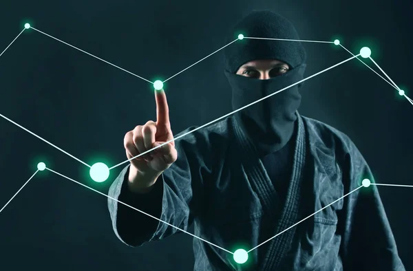 Hacker. Hacking computer data process. Man in the mask works with a digital security diagram.