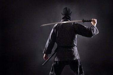 Katana ile Ninja samuray izleyiciye sırtını duruyor.