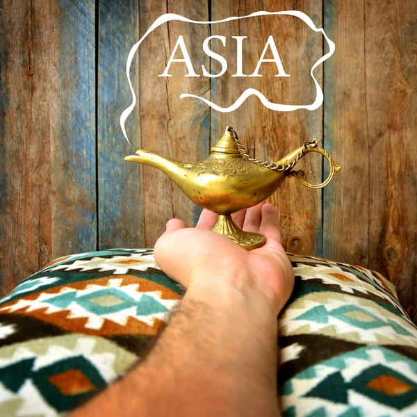 Magic Asia concept with Lamp of wishes in a hand and 