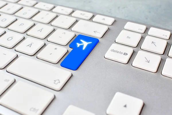 Booking air tickets online concept with keyboard and button. Check-in registration on-line.