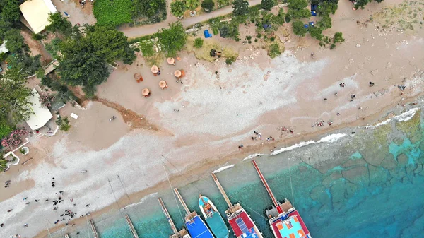 Tourists from pleasure yachts walking on the island shore