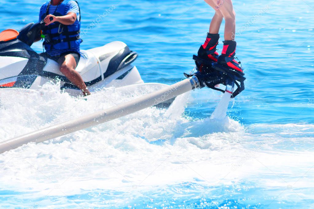 Flyboarding and seariding in a blue sea