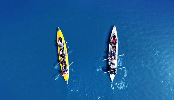 Kayaking top view. Group of kayaks rowing together. Aerial view from drone.