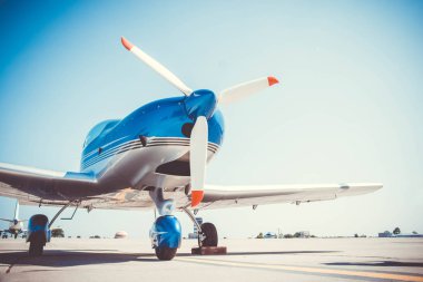 Beautiful shiny sport plane standing on airport runway 