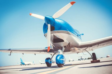 Beautiful shiny sport plane standing on airport runway 