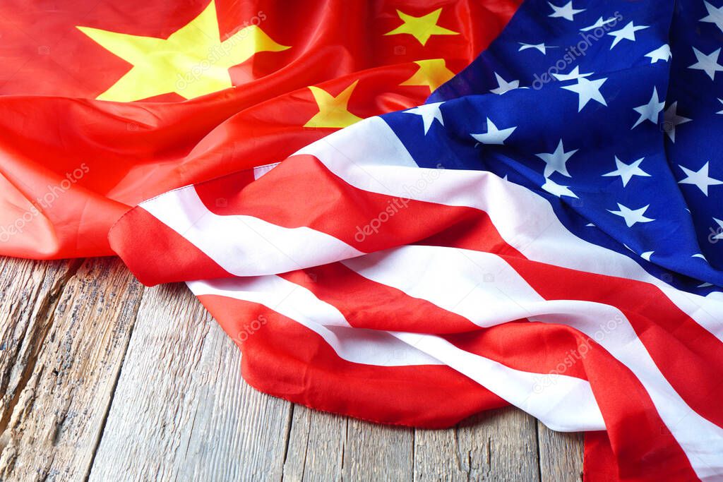 USA flag with China flag. Chinese flag and American flag on the wooden table.