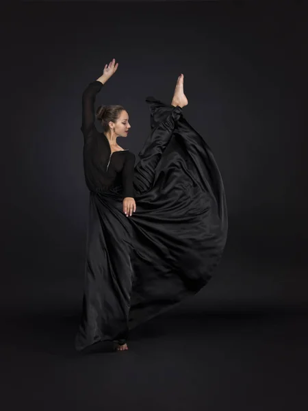 黒で女の子を笑顔に合うダンスのモダンな振り付け スタジオ撮影に暗い背景に分離イメージ — ストック写真