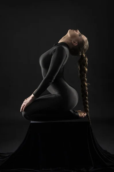 Girl Black Suit Long Hair Performs Gymnastic Exercises Studio Shot — Stock Photo, Image