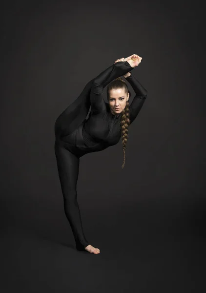 Girl Black Suit Long Hair Performs Gymnastic Exercises Studio Shot — Stock Photo, Image