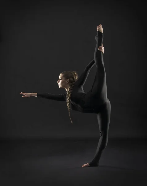 Girl Black Suit Long Hair Performs Gymnastic Exercises Studio Shot — Stock Photo, Image