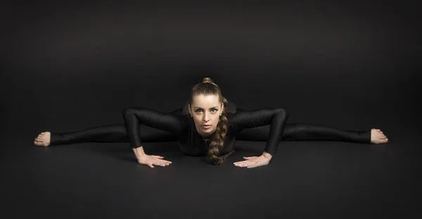 Girl Black Suit Long Hair Performs Gymnastic Exercises Studio Shot — Stock Photo, Image