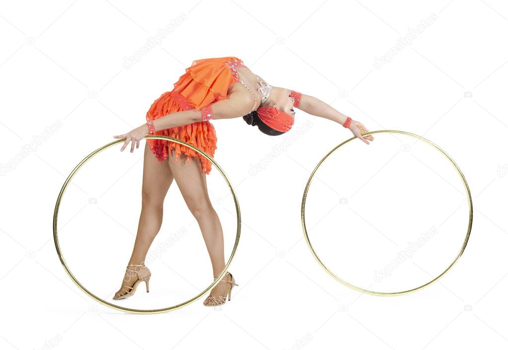 A girl in a stage dress performs a dance with a hula Hoop.