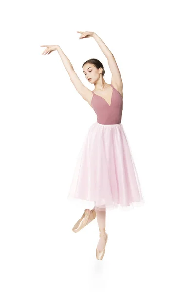 Elegant girl in a pink skirt and beige top dancing ballet. — Stock Photo, Image