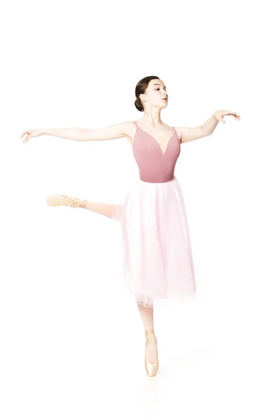 Elegant girl in a pink skirt and beige top dancing ballet. — Stock Photo, Image