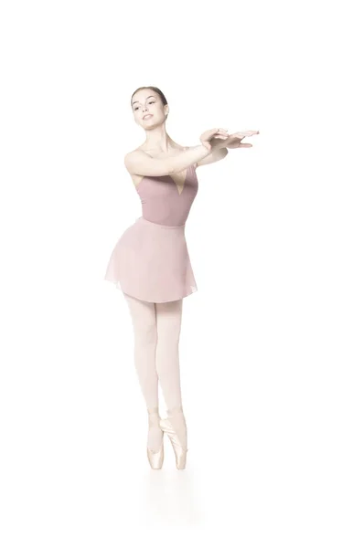 Elegant girl in a pink skirt and beige top dancing ballet. — Stock Photo, Image