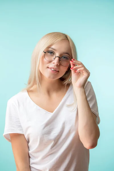 Close-up portrait of beautiful nerd isolated on the blue background — Stock Photo, Image