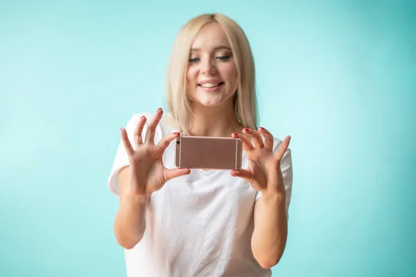 Nice girl with fair long hair taking a selfie — стоковое фото