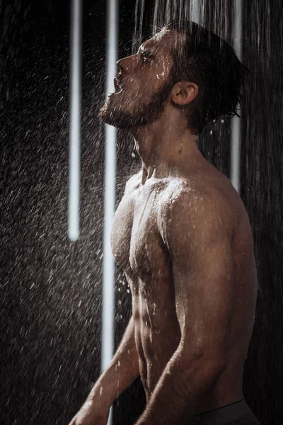 Nude man relaxing while having the shower — Stock Photo, Image