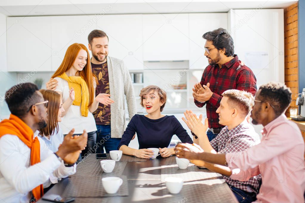 employees enjoying spending time togeter while drinking coffee